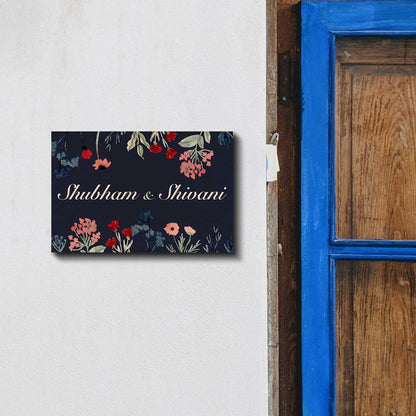 Close-up of wildflower print on navy dark floral couple name plate