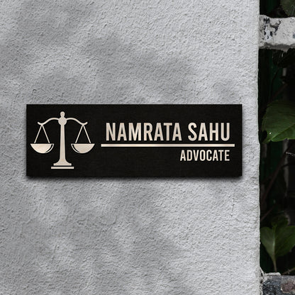 Advocate name plate with the word ADVOCATE below a bold name on black wood
