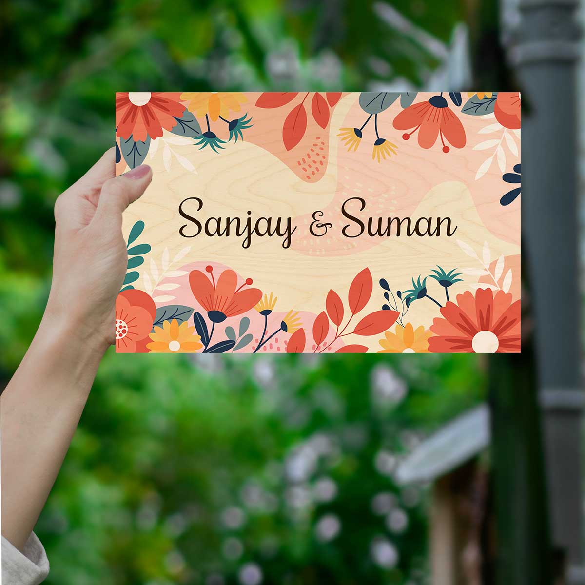 Floral name plate for home with red, coral and teal blooms along the borders