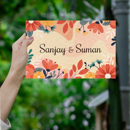 Floral name plate for home with red, coral and teal blooms along the borders
