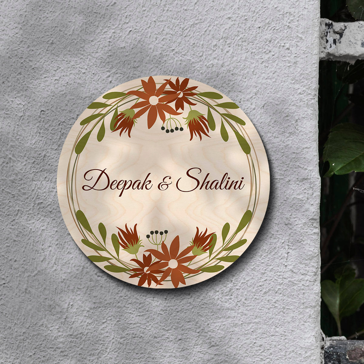 Personalised floral round name board with couple names and house number on birch
