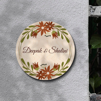 Personalised floral round name board with couple names and house number on birch