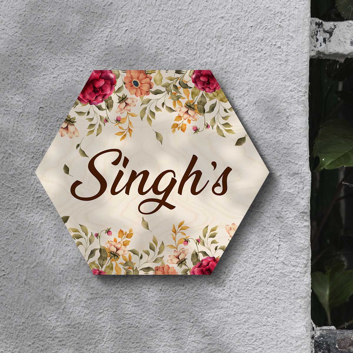 Hexagon name plate styled on wall with cream centre and floral border