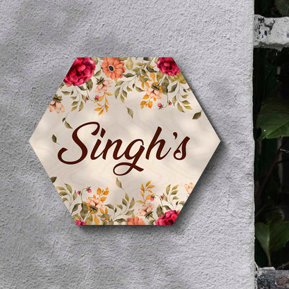 Hexagon name plate styled on wall with cream centre and floral border