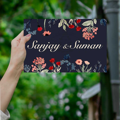 Dark floral couple name plate on main door with navy and wildflowers on birch