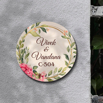 Floral-ring couple name board styled on an entrance wall in soft pastel tones